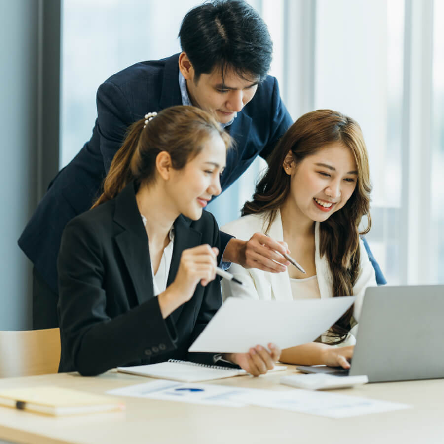 group of four happy young asian corporate people